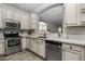 Remodeled kitchen featuring white cabinetry, stainless steel appliances, and modern countertops at 10141 E Floriade Dr, Scottsdale, AZ 85260