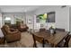 Spacious living room and dining area with hardwood floors, an entertainment center, and brown furniture at 10141 E Floriade Dr, Scottsdale, AZ 85260