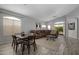 Open living room and dining area with wood floors, a brown couch, and lots of natural light at 10141 E Floriade Dr, Scottsdale, AZ 85260