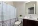Well-lit bathroom featuring a shower with patterned curtain and vanity with ample counter space at 1254 E Thomas Dr, Casa Grande, AZ 85122