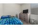 Neat bedroom with neutral tones, featuring a dresser with a TV and a large window at 1254 E Thomas Dr, Casa Grande, AZ 85122