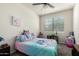 Bright bedroom with cartoon themed bedding, carpeted floors, and blinds on the windows at 1254 E Thomas Dr, Casa Grande, AZ 85122