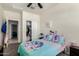 Cozy bedroom with closet and ceiling fan, featuring vibrant bedding and decor at 1254 E Thomas Dr, Casa Grande, AZ 85122