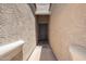 Inviting front entrance with a dark wood door and stucco walls creating a private walkway at 1254 E Thomas Dr, Casa Grande, AZ 85122