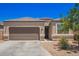 Charming single-story home featuring a two-car garage and xeriscaped front yard with a beautiful, desert tree at 1254 E Thomas Dr, Casa Grande, AZ 85122