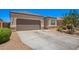Well-maintained single-story home with a two-car garage and low-maintenance front yard landscaping at 1254 E Thomas Dr, Casa Grande, AZ 85122