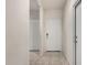 Bright hallway featuring tile flooring and white doors, offering access to various rooms at 1254 E Thomas Dr, Casa Grande, AZ 85122