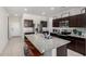 Well-appointed kitchen boasts granite counters, stainless appliances, ample cabinet space, and center island seating at 1254 E Thomas Dr, Casa Grande, AZ 85122