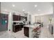 Modern kitchen with granite countertops, stainless steel appliances, and seating at the island at 1254 E Thomas Dr, Casa Grande, AZ 85122