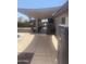 Outdoor patio featuring a shaded area with an outdoor TV and dining set by the pool at 14938 W Mauna Loa Ln, Surprise, AZ 85379