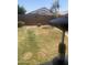 Backyard with grass and desert landscaping in a fenced in yard at 14938 W Mauna Loa Ln, Surprise, AZ 85379