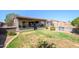 Spacious backyard with a covered patio, small pool, and block fencing, perfect for outdoor entertaining at 14938 W Mauna Loa Ln, Surprise, AZ 85379