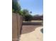 Landscaped backyard featuring rock ground cover, with green shrubbery, enhancing the home's outdoor appeal at 14938 W Mauna Loa Ln, Surprise, AZ 85379