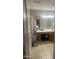 Bright bathroom featuring a neutral color scheme, vanity with ample counter space and storage at 14938 W Mauna Loa Ln, Surprise, AZ 85379