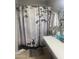 Bathroom featuring a shower with patterned curtains at 14938 W Mauna Loa Ln, Surprise, AZ 85379