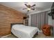 Comfortable bedroom with wood accent wall and ceiling fan at 14938 W Mauna Loa Ln, Surprise, AZ 85379