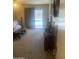 Bedroom with door to the backyard and pool at 14938 W Mauna Loa Ln, Surprise, AZ 85379