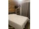 Bedroom featuring a paneled wall, soft lighting, and neutral color palette at 14938 W Mauna Loa Ln, Surprise, AZ 85379