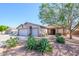 Charming single-story home featuring desert landscaping, a spacious three-car garage, and a well-maintained front yard at 14938 W Mauna Loa Ln, Surprise, AZ 85379