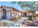Attractive single-story home with a three-car garage, desert landscaping, and inviting entryway under a clear blue sky at 14938 W Mauna Loa Ln, Surprise, AZ 85379