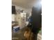 A cluttered garage space featuring a refrigerator, storage items, and a black storage unit at 14938 W Mauna Loa Ln, Surprise, AZ 85379