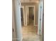 Hallway with open doorways leading to rooms, showing a tiled floor at 14938 W Mauna Loa Ln, Surprise, AZ 85379