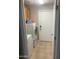 Laundry room with front-loading washer and dryer, storage cabinets, and tiled floor at 14938 W Mauna Loa Ln, Surprise, AZ 85379