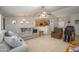 Spacious living room with comfortable seating, a ceiling fan, and an open view into the kitchen area at 14938 W Mauna Loa Ln, Surprise, AZ 85379