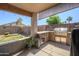 Stylish outdoor kitchen with a built-in grill, refrigerator, and stone accents, ideal for al fresco dining at 14938 W Mauna Loa Ln, Surprise, AZ 85379