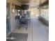 Outdoor seating area featuring a table, chairs and TV for entertainment at 14938 W Mauna Loa Ln, Surprise, AZ 85379