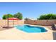 Private pool with red umbrella in the backyard at 14938 W Mauna Loa Ln, Surprise, AZ 85379