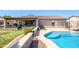 Pool with covered patio and outdoor kitchen area at 14938 W Mauna Loa Ln, Surprise, AZ 85379