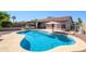 Sparkling pool with patio, backyard landscaping and lounge area at 14938 W Mauna Loa Ln, Surprise, AZ 85379