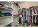 Walk-in closet with shelving and racks for clothing and shoe storage at 14938 W Mauna Loa Ln, Surprise, AZ 85379