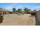 The backyard showcases desert landscaping, a relaxing hammock, and perimeter flowerbeds at 1559 S Padre Rd, Apache Junction, AZ 85119