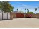 Backyard with a metal storage shed and surrounded by block wall with flowerbeds at 1559 S Padre Rd, Apache Junction, AZ 85119