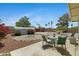 Landscaped backyard with a desert theme including decorative rock, hammock and patio set at 1559 S Padre Rd, Apache Junction, AZ 85119