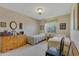 Shared bedroom features twin beds, floral wallpaper and dresser for storage at 1559 S Padre Rd, Apache Junction, AZ 85119