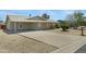 Wide driveway with a charming home in the background and desert landscaping providing curb appeal at 1559 S Padre Rd, Apache Junction, AZ 85119