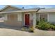 Inviting exterior featuring a red door adorned with a wreath and a charming rocking chair on the front porch at 1559 S Padre Rd, Apache Junction, AZ 85119