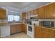 Functional kitchen with wooden cabinets and essential appliances at 1559 S Padre Rd, Apache Junction, AZ 85119