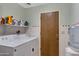 Laundry room featuring white washer and dryer, shelving with supplies, and a back door at 1559 S Padre Rd, Apache Junction, AZ 85119