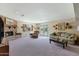 Spacious living room has a brick fireplace, neutral carpet, and comfortable furnishings at 1559 S Padre Rd, Apache Junction, AZ 85119