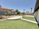 Large backyard with lush green grass, landscaping, concrete patio, and block wall fence at 16414 S 36Th St, Phoenix, AZ 85048