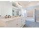 Light-filled bathroom with dual sink vanity, large mirror, tub, and tiled walk-in shower at 16414 S 36Th St, Phoenix, AZ 85048