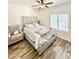 Cozy bedroom features a cushioned bed frame, plush chair, and sunlit window at 16414 S 36Th St, Phoenix, AZ 85048