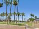 Picturesque community park with lush greenery, palm trees, gazebo, and access to the serene lake at 16414 S 36Th St, Phoenix, AZ 85048