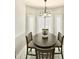 Bright dining area with modern light fixture and views from windows with plantation shutters at 16414 S 36Th St, Phoenix, AZ 85048
