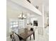 Elegant dining room featuring a chandelier, a dining table with six chairs, and an adjacent living area at 16414 S 36Th St, Phoenix, AZ 85048