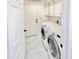 Neat laundry room with modern white appliances, cabinet storage, and stylish flooring at 16414 S 36Th St, Phoenix, AZ 85048